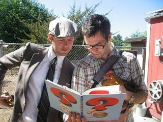 Mac Barnett (left) and Adam Rex (right) read from their book _Guess Again!_ Photo via Barnett and Rex's blog Guys WIth Books