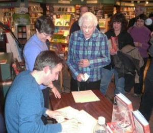 Amick signs copies of his novel at Nicola's Books / photo from the Ann Arbor Chronicle